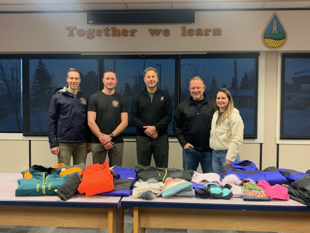 The FSJ Firefighters Charitable Society swung by the SD60 Board Office this morning with three large boxes filled with top quality winter clothing from local store Lux Apparel.  Thanks to this donation, several of our students will be warmer on the way to school.  Many thanks to our firefighters!