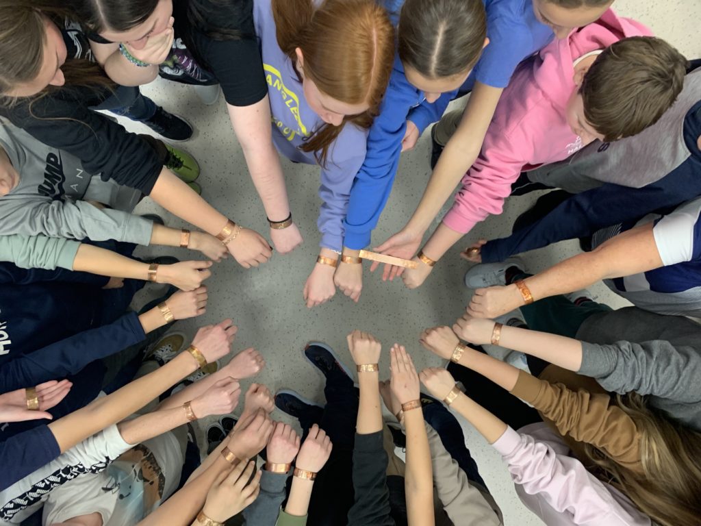 Students showing bracelets they have created during Skills Ready BC workshop